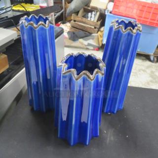 Blue ceramic candle holders with wavy edges, set of three, in excellent condition, glossy finish.