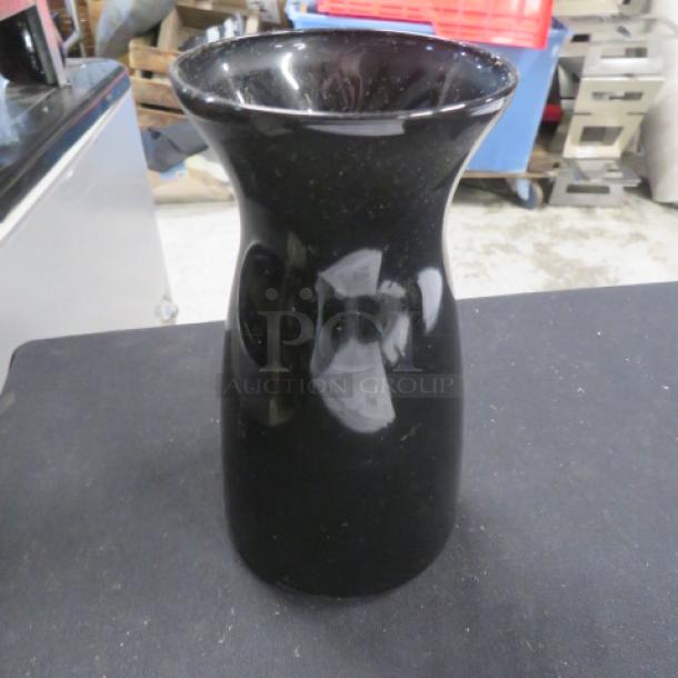 Black tabletop vase with glossy finish, flared rim. In good condition, approximately 12 inches tall, model 12XBID.