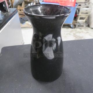 Black tabletop vase with glossy finish, approx. 12 inches tall, in good condition. Smooth, modern design suitable for decor.