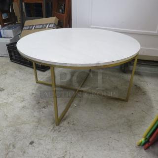 Round table with gold frame and marble-look top, 36x18 inches. Sturdy condition, modern design, suitable for living spaces.