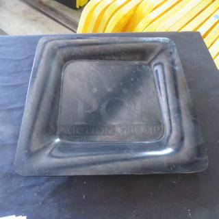 Carlisle 12-inch square melamine plate, model N44400, in used condition. Black with a slightly raised edge.