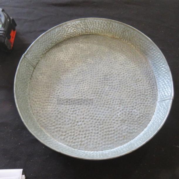 10.5" metal hammered plate, round design, textured surface, appears in good condition. Ideal for decorative use.