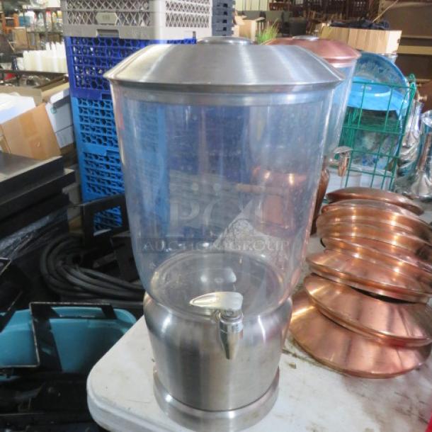 Stainless steel beverage dispenser with clear container and silver spigot, in excellent condition.