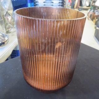 Ribbed brown glass vase, cylindrical shape, part of a collection of 13 vases, displayed on black surface.