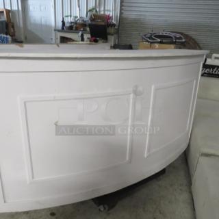 Curved wooden portable bar, 77x30x42 inches, white finish, under storage, minor wear visible, ideal for events.