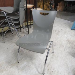 Gray metal wooden stack chair with chrome legs, ergonomic back, and minor surface wear. Stackable design for easy storage.