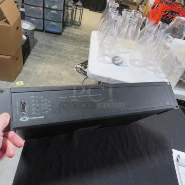 Crestron AV2 Audio Video Control Processor, black, model #AV2, in used condition, showing front panel with ports and branding.