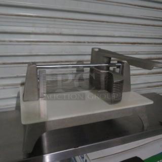 Commercial tomato slicer with stainless steel blades and sturdy base, good condition, suitable for high-volume use.