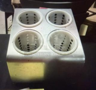 Stainless steel flatware holder with four perforated compartments, in good condition. Ideal for organizing utensils.