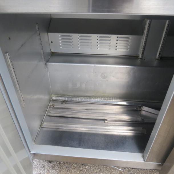 Hoshizaki CRMR-72-30M prep table, 3 doors, cutting board, 2 racks, on casters, stainless interior, model tag visible.