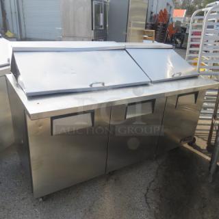 True 3-door refrigerated prep table on casters, 72"x34"x48", model TSSU-72-30M-B-ST, stainless steel, excellent condition.