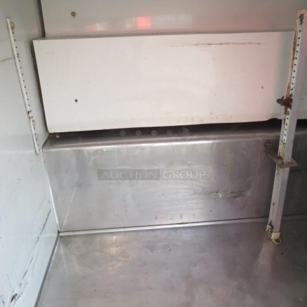 True 3 Door Refrigerated Prep Table, Model TSSU-72-30M-B-ST, on casters. 72x34x48 inches, 115V, steel interior.