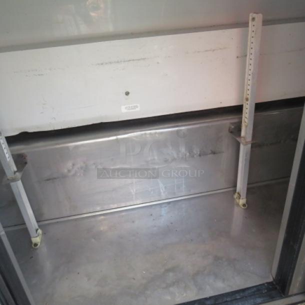 True 3-door refrigerated prep table, model TSSU-72-30M-B-ST, in working condition, 72x34x48 inches, on casters.