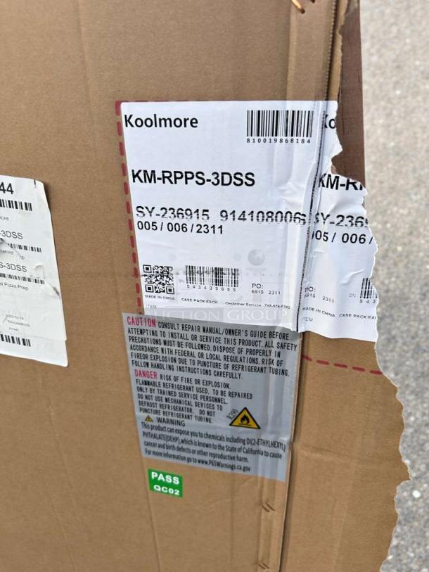 Alt text: "Brand New Koolmore 72-inch Refrigerated Pizza Prep Refrigerator, Model KM-RPPS-3DSS, in scratch and dent condition. Box with visible labels and warnings."