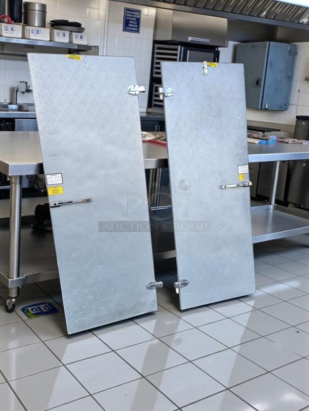 Nor-Lake walk-in cooler/freezer doors in immaculate condition, fully inspected, ready for installation, with safety labels.