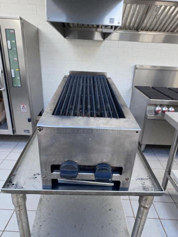 Commercial-grade 24" gas charbroiler, stainless steel, outstanding condition, fully tested, lava rock grill.