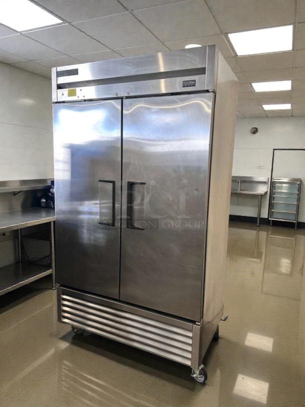 Stainless steel, commercial-grade, two-door reach-in refrigerator; bottom-mount, immaculate condition, fully tested.
