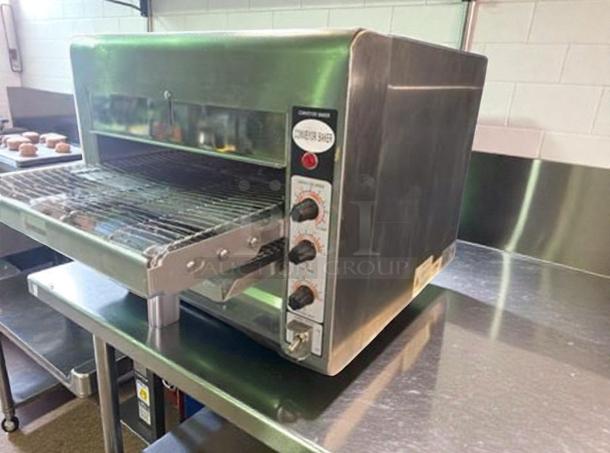 Omcan TS-7000 conveyor toaster oven, superior condition, stainless steel, 208V, UL listed, fully operational controls shown.