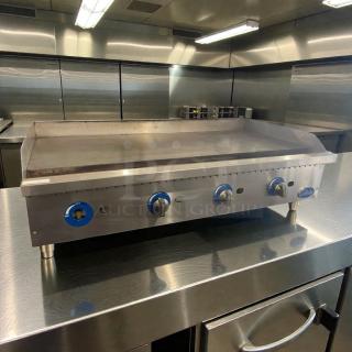 Pristine Globe commercial gas griddle, stainless steel, fully tested, three blue knobs, excellent condition, data plate visible.