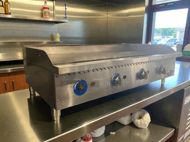 Globe Commercial Gas Griddle in pristine condition, stainless steel, featuring control knobs and sturdy legs. Fully tested and working.