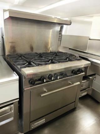 American Range 6-burner gas range with oven, excellent condition, stainless steel, fully tested, commercial model.