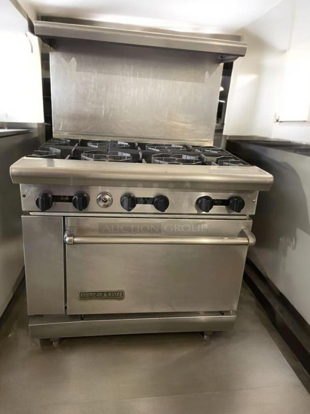 American Range 6-burner gas range with oven, excellent condition, fully tested, American Range Corporation logo visible.