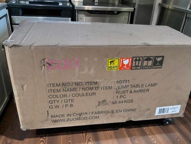 Brand new Zuomor Jump Table Lamp set, 3-light, rustic amber glass, new in original box. Model: 50301.