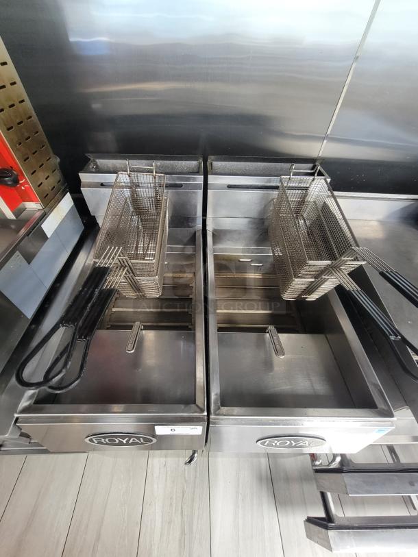 Pair of Royal REEF-35 commercial deep fryers, stainless steel, with baskets. Natural gas-powered, 24,000 BTU/hr per burner.