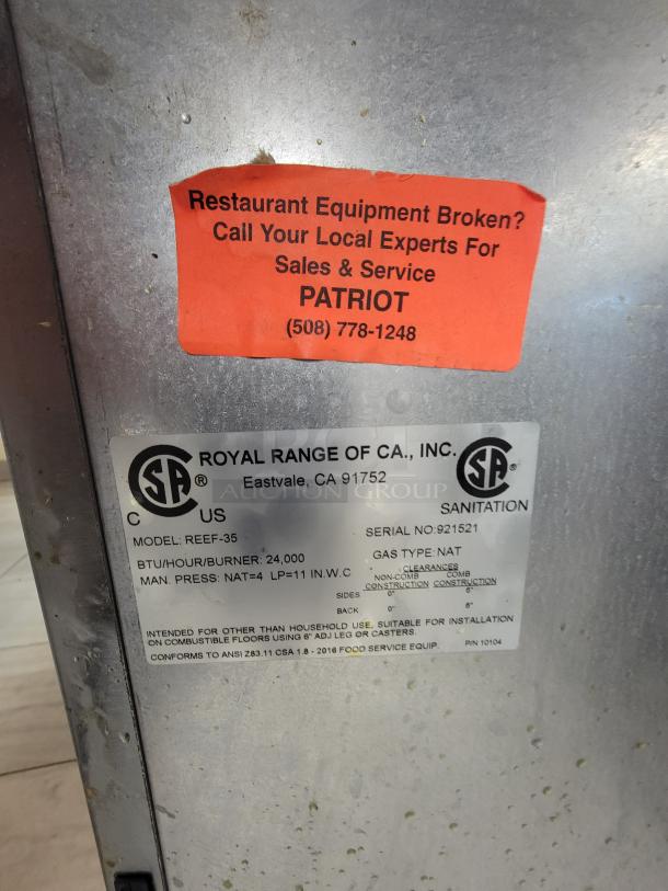 Pair of Royal REEF-35 commercial deep fryers, natural gas, 24,000 BTU/hr per burner, stainless steel, includes baskets.