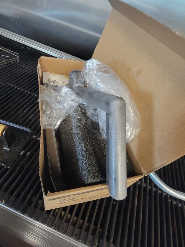 Royal RRB-48 4' Commercial NG Charbroiler with cast iron grates, grill press, basting cover, scraper, and brush, in solid used condition.