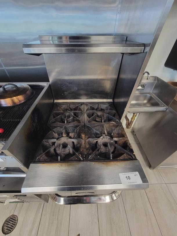 Royal RRE-24 commercial 4-burner range, stainless steel, with oven, gas safety tether, and backsplash, in excellent condition.