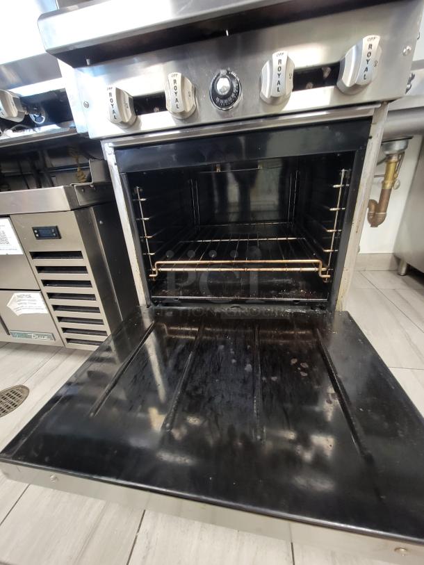 Royal RRE-24 commercial range & oven with 4 burners, stainless finish, gas safety tether, adjustable racking, excellent condition.
