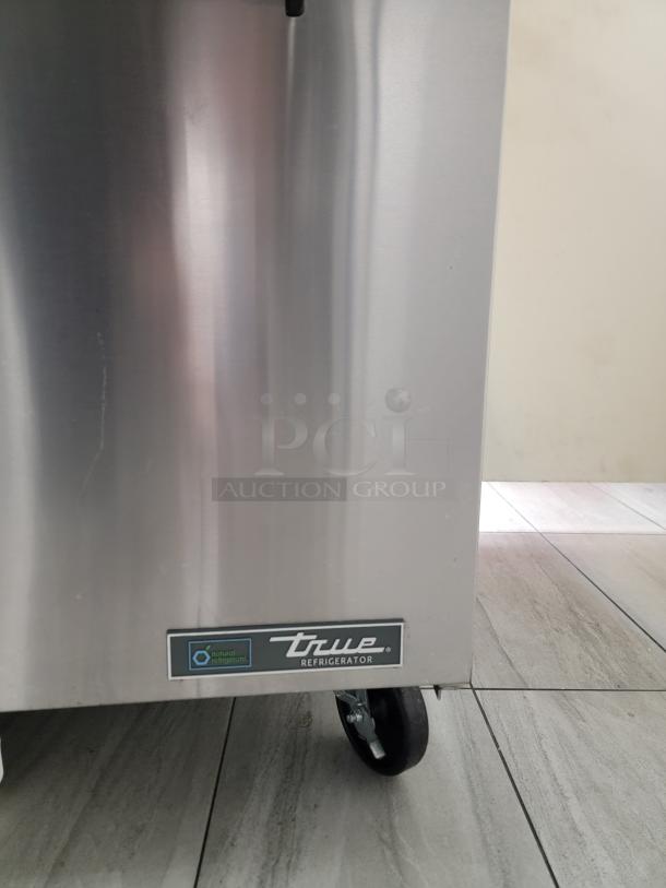 True TSSU-48-18M-B-HC prep table, stainless steel, eco-friendly R290 refrigerant, heavy-duty casters, visible brand label.