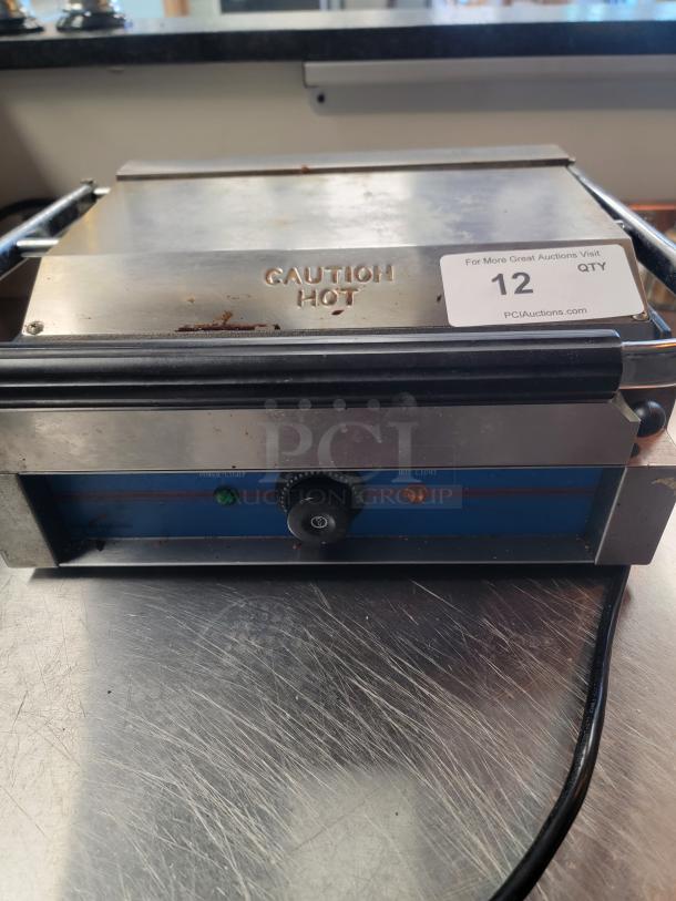 Rocket RC-GH-811EC commercial panini press with grooved top, smooth bottom, temp dial, dual indicator lights, and "Caution Hot" label.
