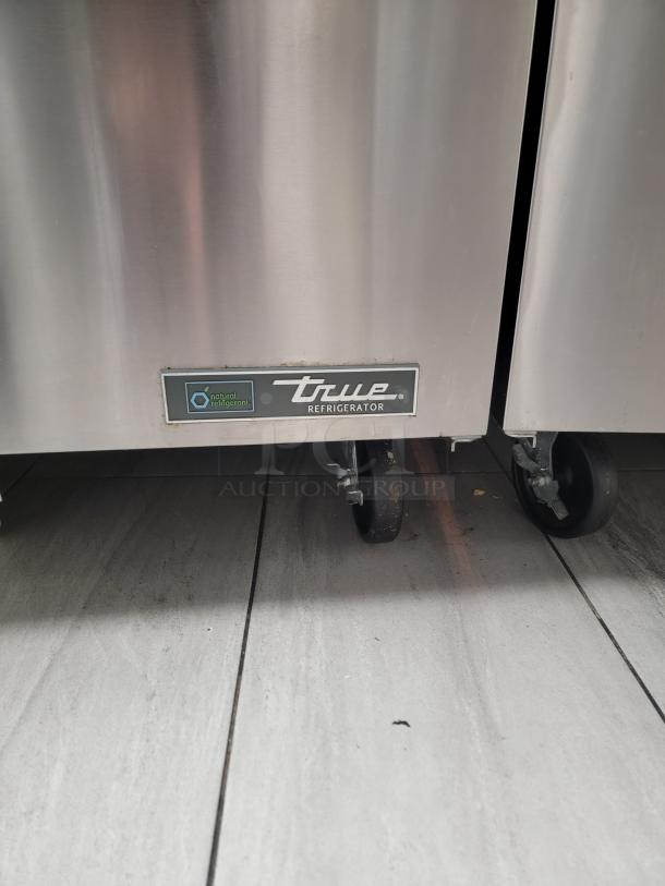 Commercial True TWT-48-HC Worktop Refrigerator, like new condition, stainless steel, eco-friendly R290 refrigerant, on casters.