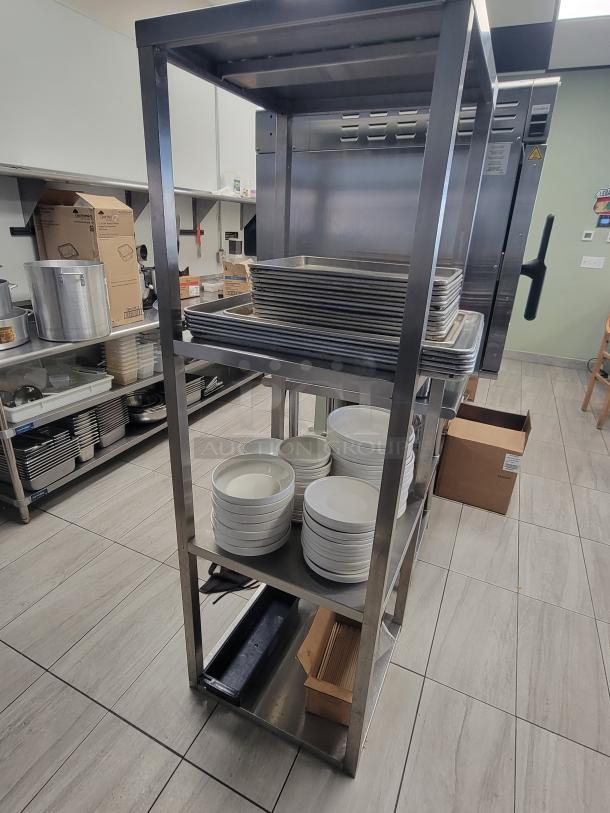 Heavy-duty stainless steel shelving unit with sheet pans, ceramic plates, bowls; ideal for commercial kitchens, catering use.