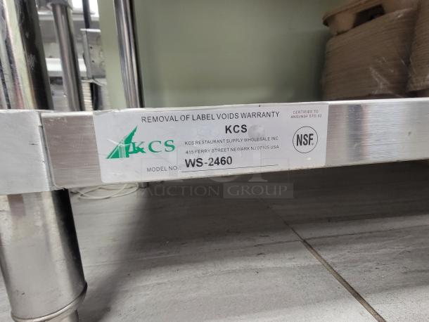 KCS Stainless Steel Work Table, model WS-2460. Label shows specs and NSF certification. Includes bulk supplies.