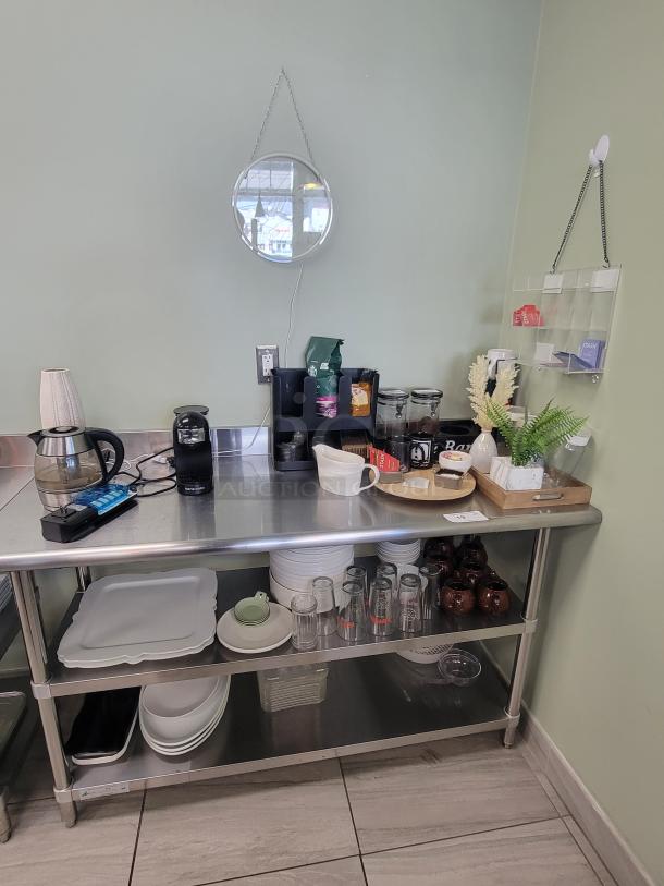 Stainless steel coffee and tea station, model KCS HS-2460, featuring Bene Casa espresso maker, kettle, Starbucks coffee, Stash tea, mugs, plates, and a neon "Coffee and Tea" sign.