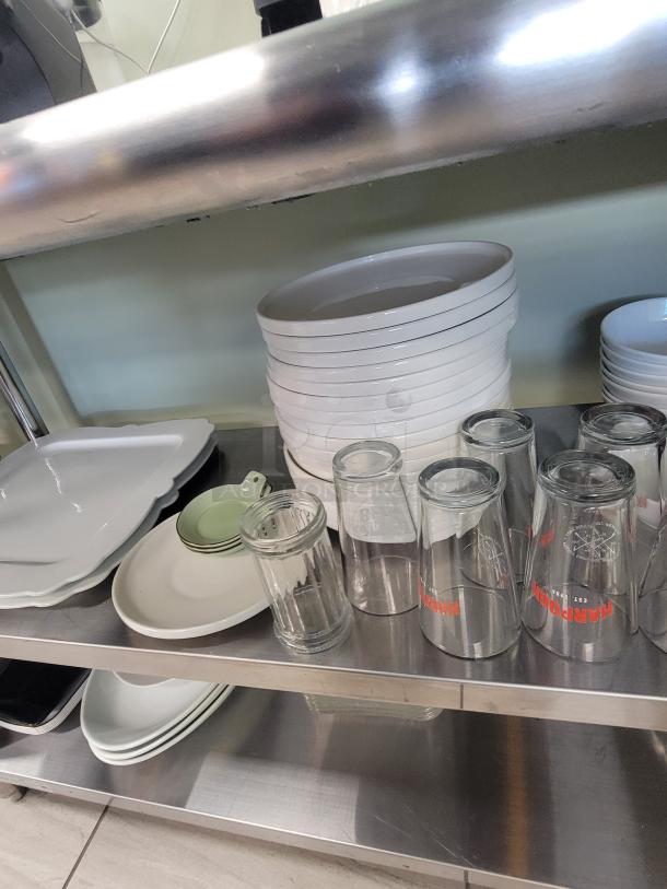 Stainless steel coffee and tea station by KCS, model HS-2460. Includes plates, glasses, mugs, and "Coffee and Tea" neon sign.