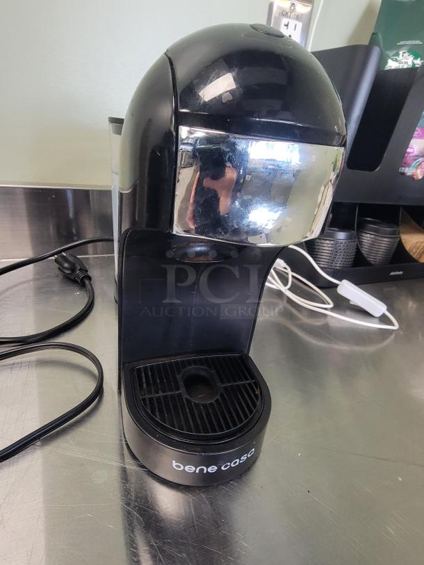 Bene Casa espresso maker on stainless steel surface, part of a 5-foot KCS HS-2460 coffee and tea station with neon sign.