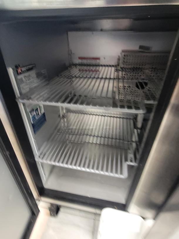 True TUC-36-HC under-counter fridge, stainless steel, dual doors, excellent condition, smooth-rolling casters, spacious interior.