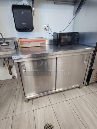 KCS Commercial Stainless Steel Prep Table with sliding doors, interior shelf, digital microwave, and plastic food wrap. Model 415.