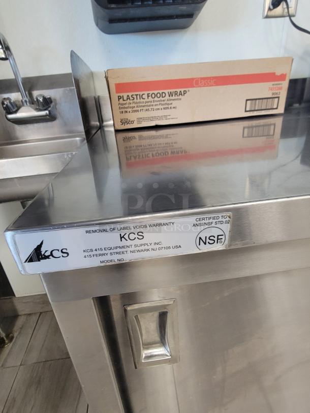 KCS 415 stainless prep table with storage, sliding doors, shelf. Includes digital microwave, 18" plastic wrap, cookware. Excellent condition.