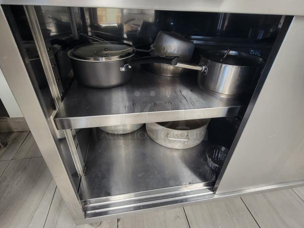 KCS Commercial Stainless Steel Prep Table with sliding doors, interior shelf; includes stainless pots, pans, and kitchen essentials.