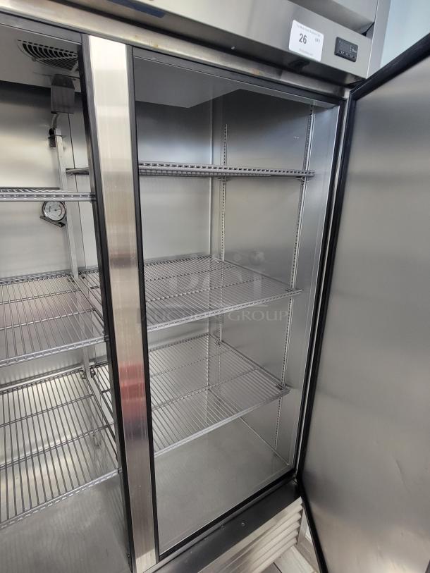 True T-49-HC double door refrigerator, stainless steel, pristine condition, with shelves and energy-efficient refrigerant.