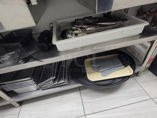 9' Sapphire Professional stainless workstation with utensils, pans, trays, and oven mitts. Ideal for commercial kitchens.