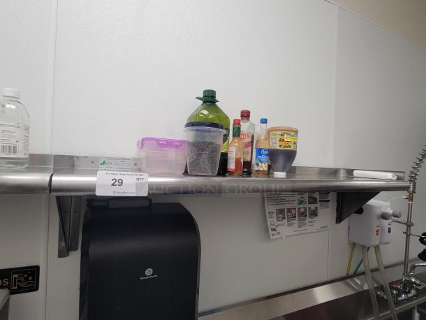 Stainless steel wall shelf KCS WSSL-24X with kitchen essentials: olive oil, sauces, honey, containers. NSF-certified.