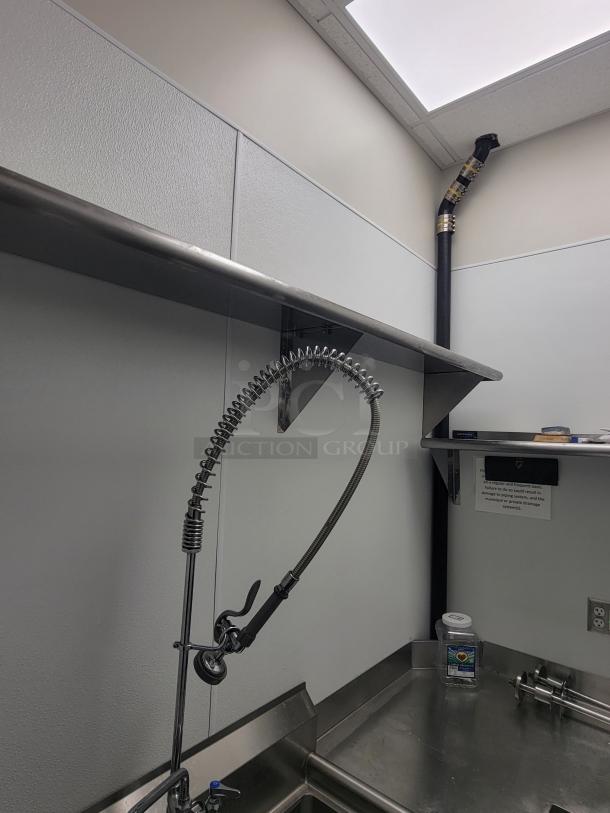 Commercial kitchen dish station with stainless steel setup, pre-rinse sprayer, by KCS and Sapphire. Professional-grade condition.