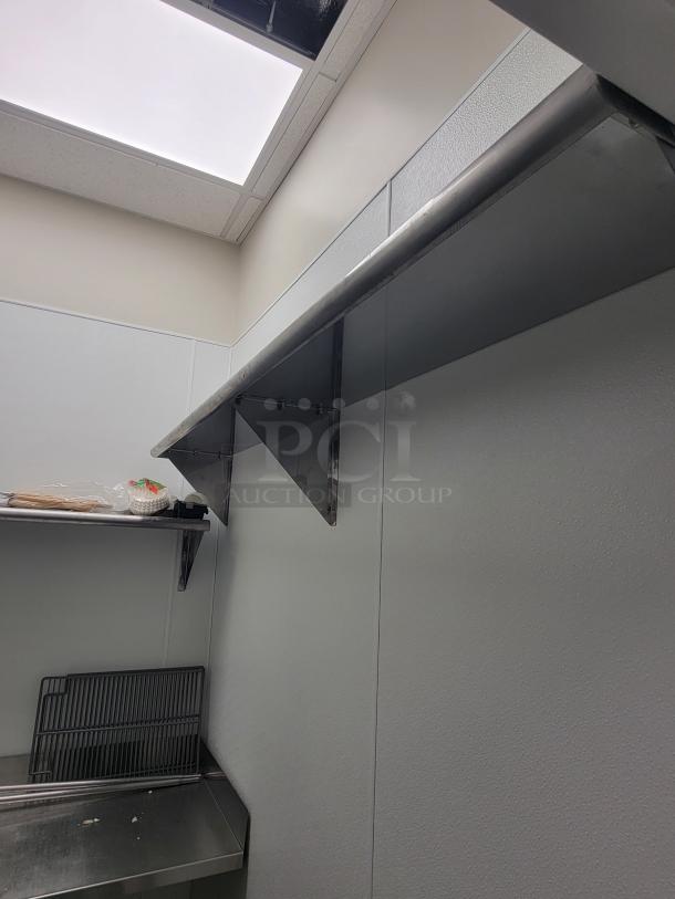 Professional-grade stainless steel kitchen dish station setup, featuring shelves and a prep area. Ideal for commercial use.