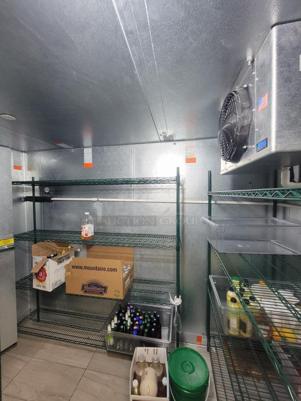 Norlake walk-in cooler/freezer combo with wall-mounted condensing units and green Metro shelving, excellent condition.